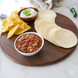 charcuterie board with tortillas and chips
