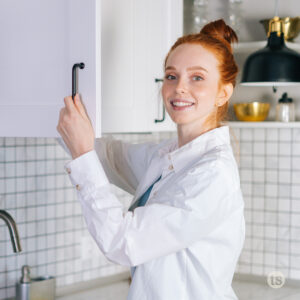 Woman standing in front of cupboard to clean out