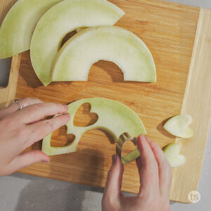 Cutting fruit with a heart shaped cookie cutter