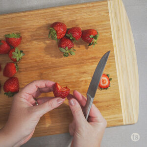 Cutting strawberries in the shape of hearts