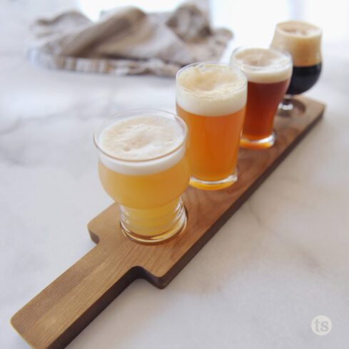 Four different beers on a flight board