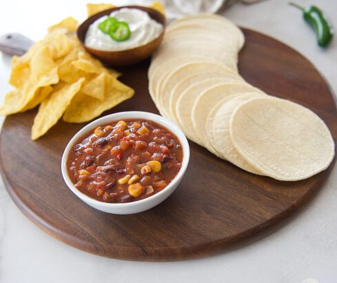 charcuterie board with tortillas and chips