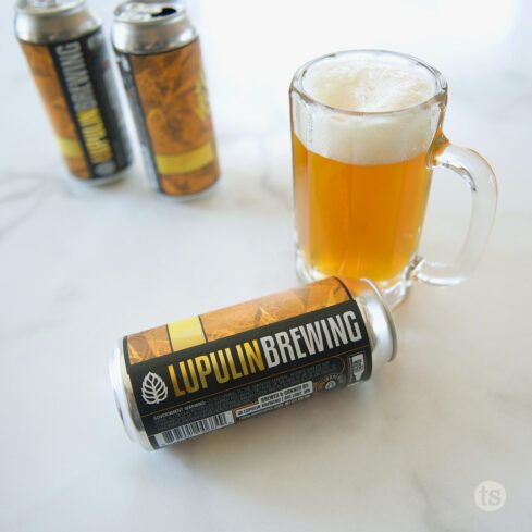 Lupulin Brewing Cans with Glass of Beer