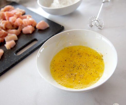 Egg wash in bowl with seasonings